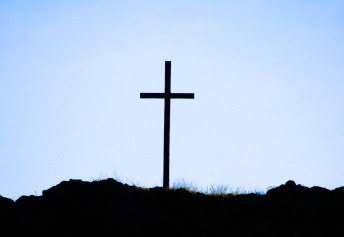A wooden cross on a hill